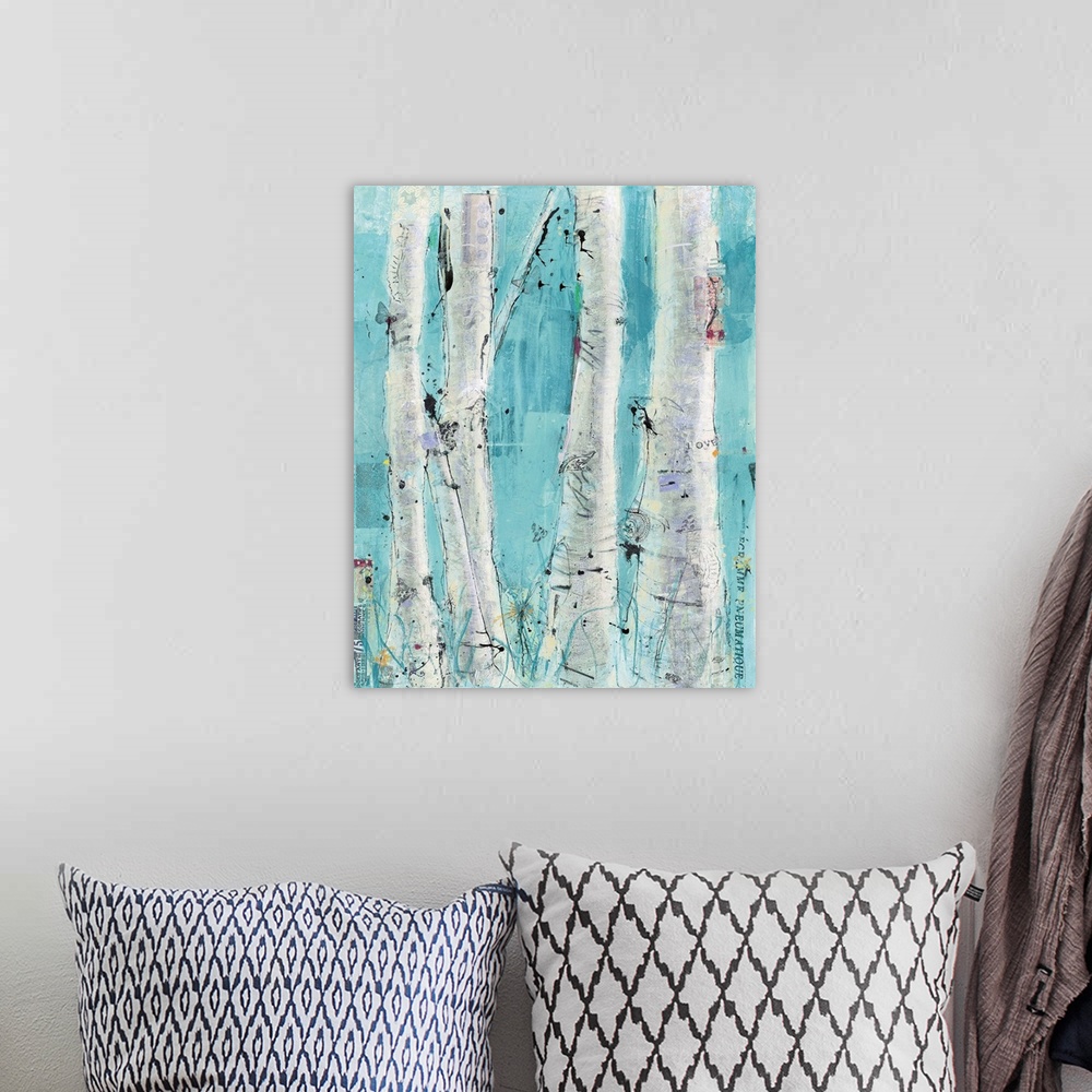 A bohemian room featuring A painting of a group of birch trees with layers of small text and decorative images.