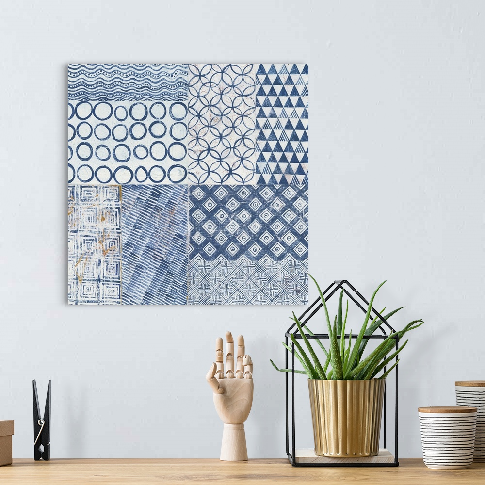 A bohemian room featuring Contemporary artwork of different pattern tiles in a faded navy blue side by side against a neutr...