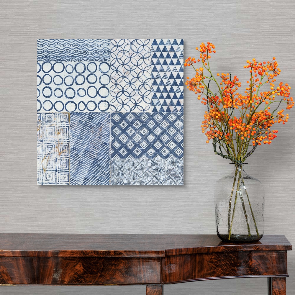A traditional room featuring Contemporary artwork of different pattern tiles in a faded navy blue side by side against a neutr...