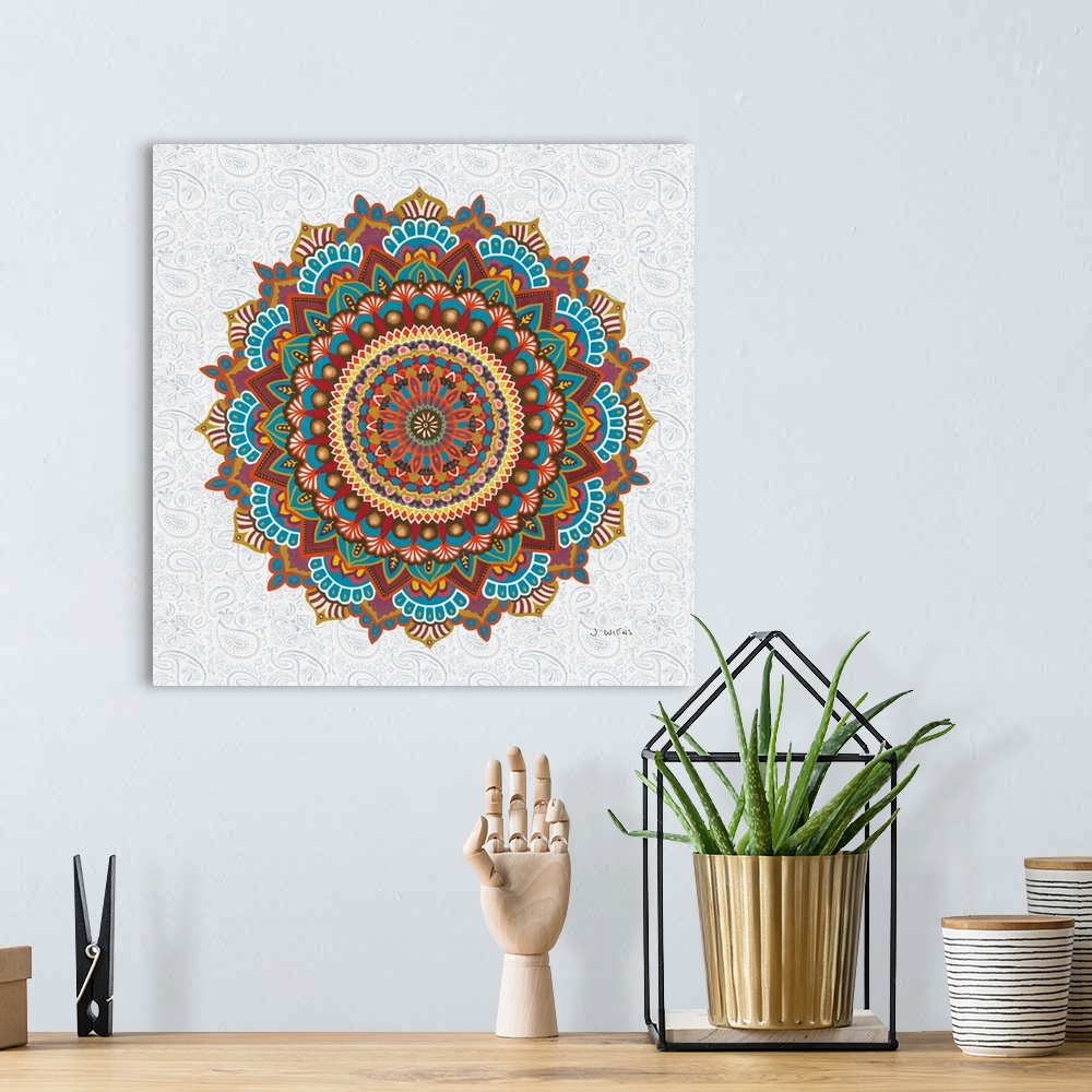 A bohemian room featuring A beautifully colored mandala design in warm tones on a paisley patterned background.