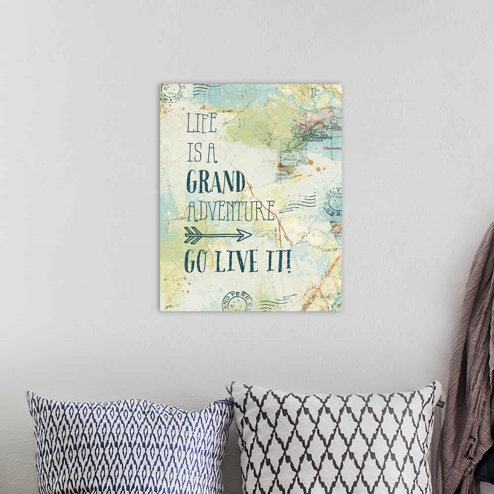A bohemian room featuring "Life is a Grand Adventure. Go Live It!" written on top of a map and postage stamp collage.