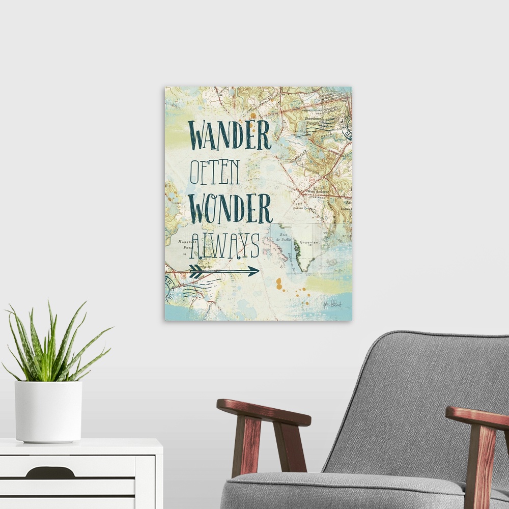 A modern room featuring "Wander Often Wonder Always" written on top of a map and postage stamp collage.