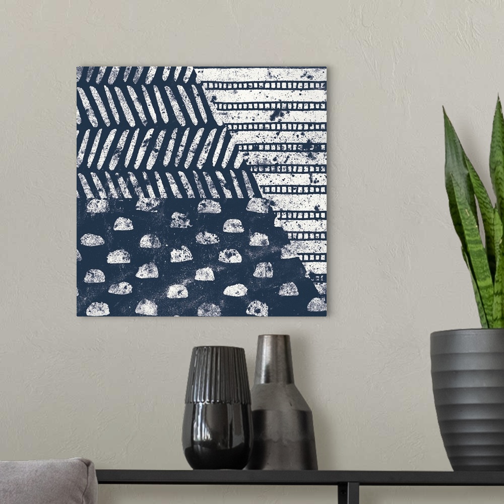 A modern room featuring Square abstract art with indigo and white patterns.
