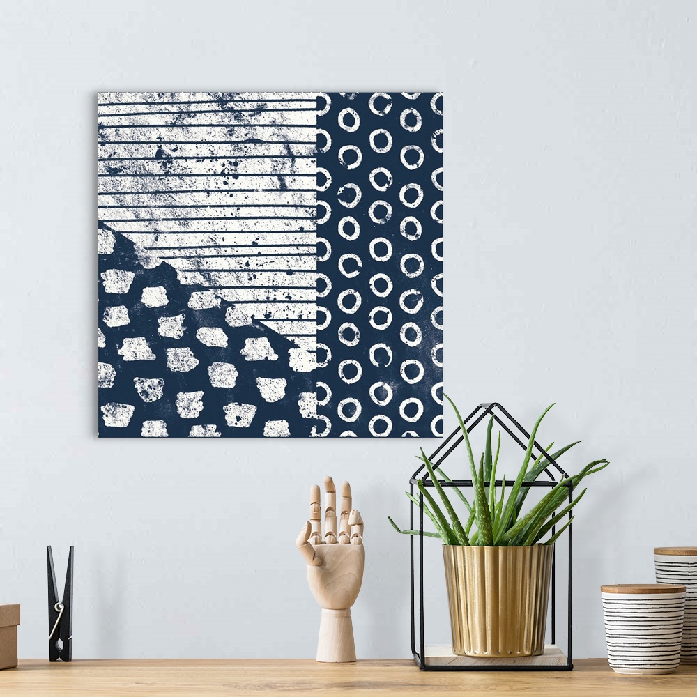 A bohemian room featuring Square abstract art with indigo and white patterns.