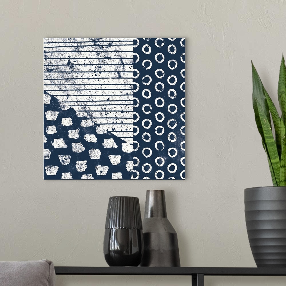 A modern room featuring Square abstract art with indigo and white patterns.