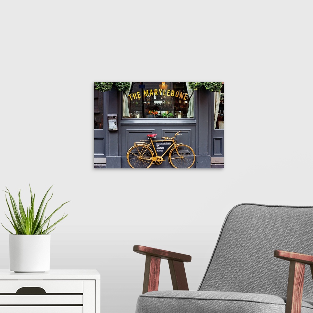 A modern room featuring Photograph of a gold bike leaning up against The Marylebone, advertising their cocktails, London,...