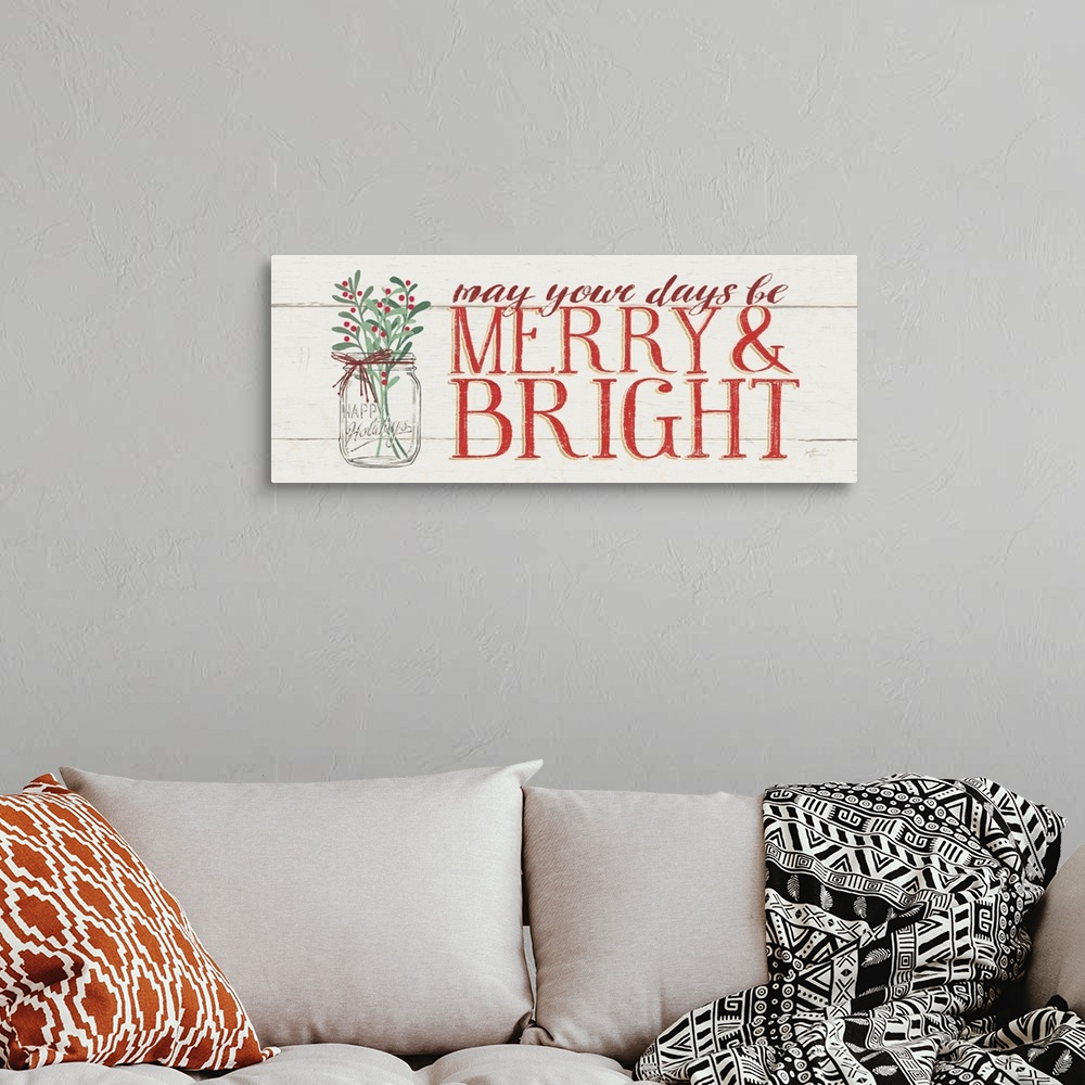 A bohemian room featuring Decorative artwork of a mason jar of holly with the text "may your days be Merry and Bright" on a...