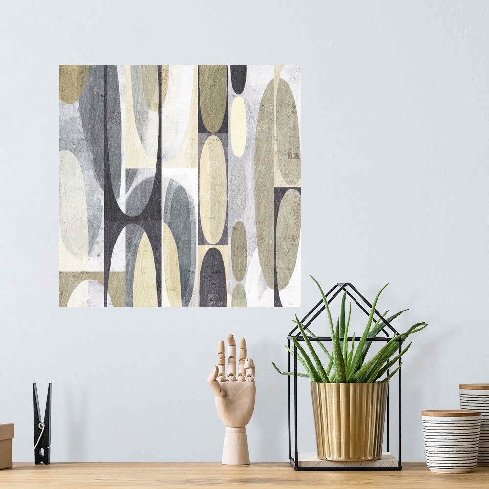 A bohemian room featuring Neutral colored mid century modern decor with layered shapes.