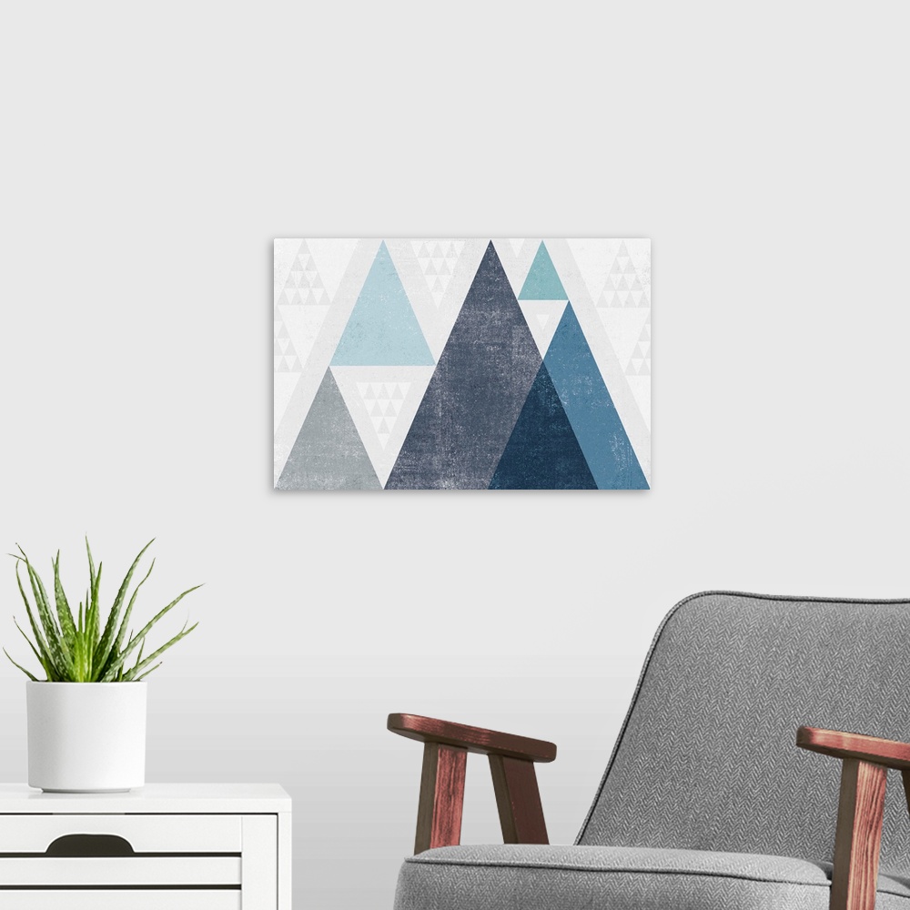 A modern room featuring Abstract geometric artwork of a triangle design in cool blue.