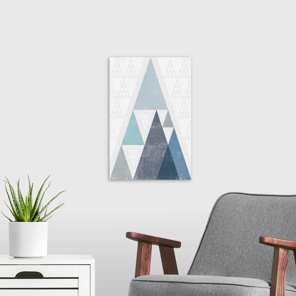 A modern room featuring Abstract artwork with a triangle design in cool blue tones.