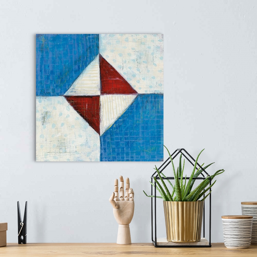 A bohemian room featuring Contemporary folk art style painting of a geometric quilt pattern in red white and blue.