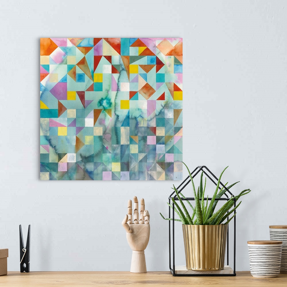 A bohemian room featuring Abstract artwork with colorful patchwork with geometric shapes on a square canvas.
