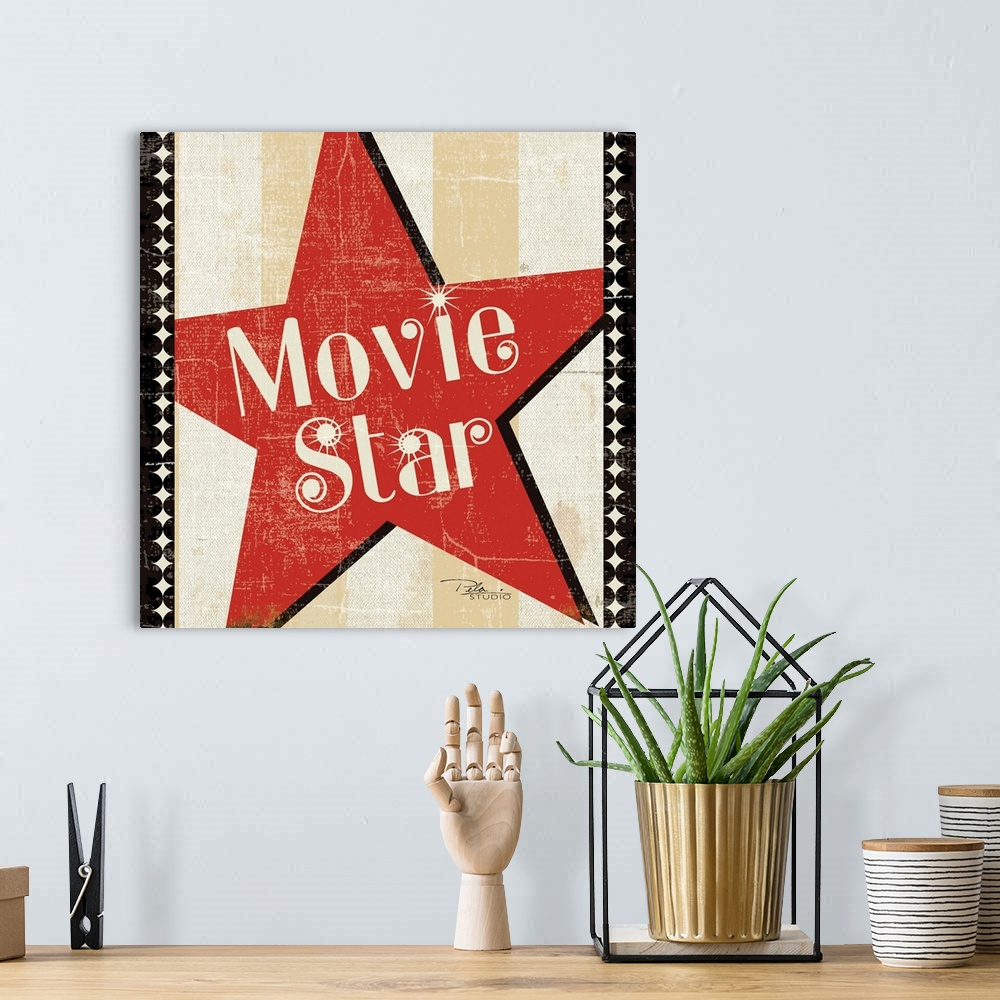 A bohemian room featuring Contemporary artwork of a Hollywood star icon in red with text in the center of it.