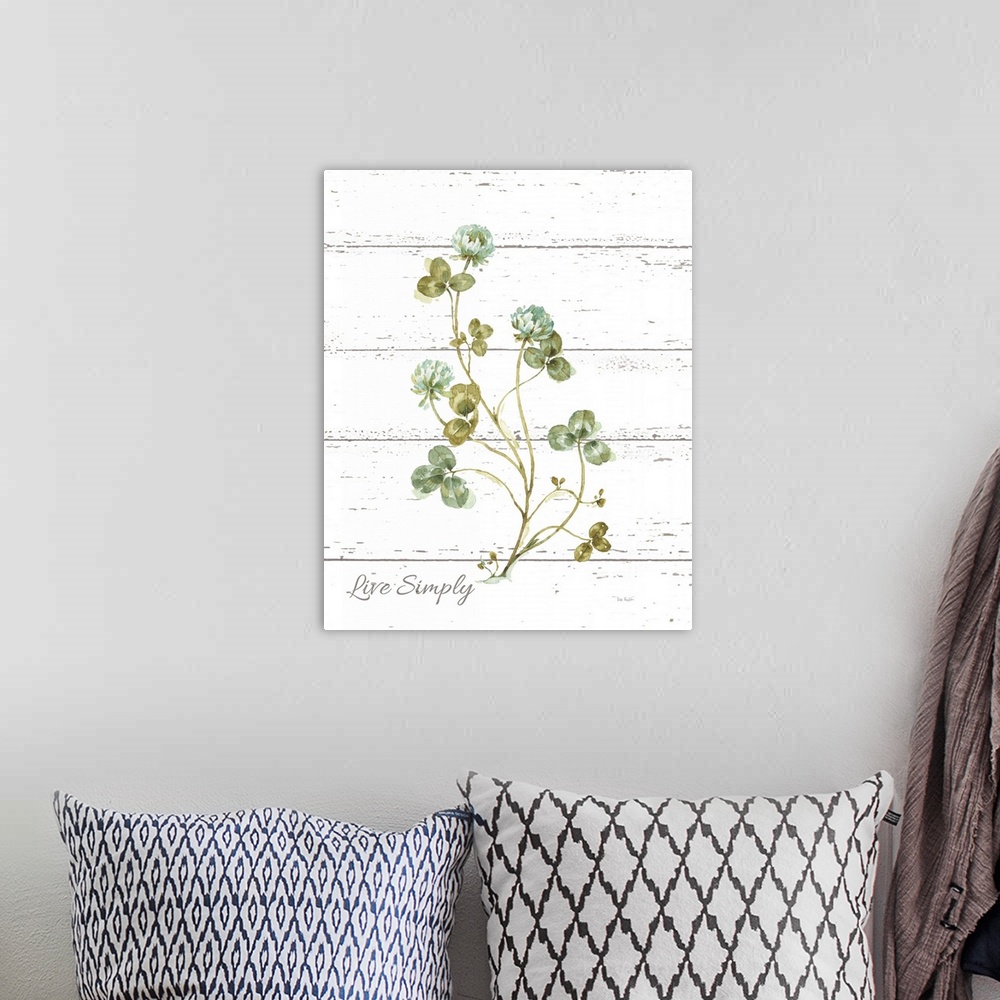 A bohemian room featuring "Live Simply" with clover on a white wood panel backdrop.