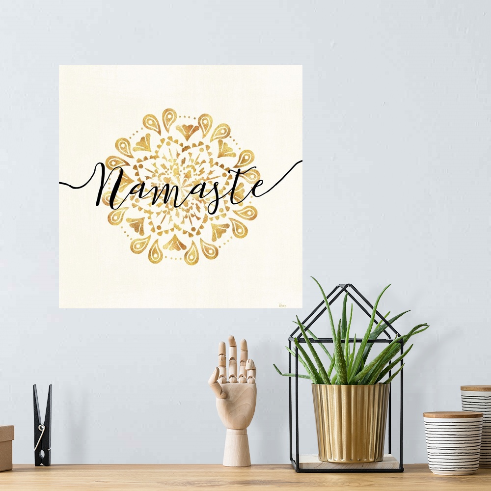 A bohemian room featuring Shiny gold mandala on a neutral background with the word "Namaste" written through the center.