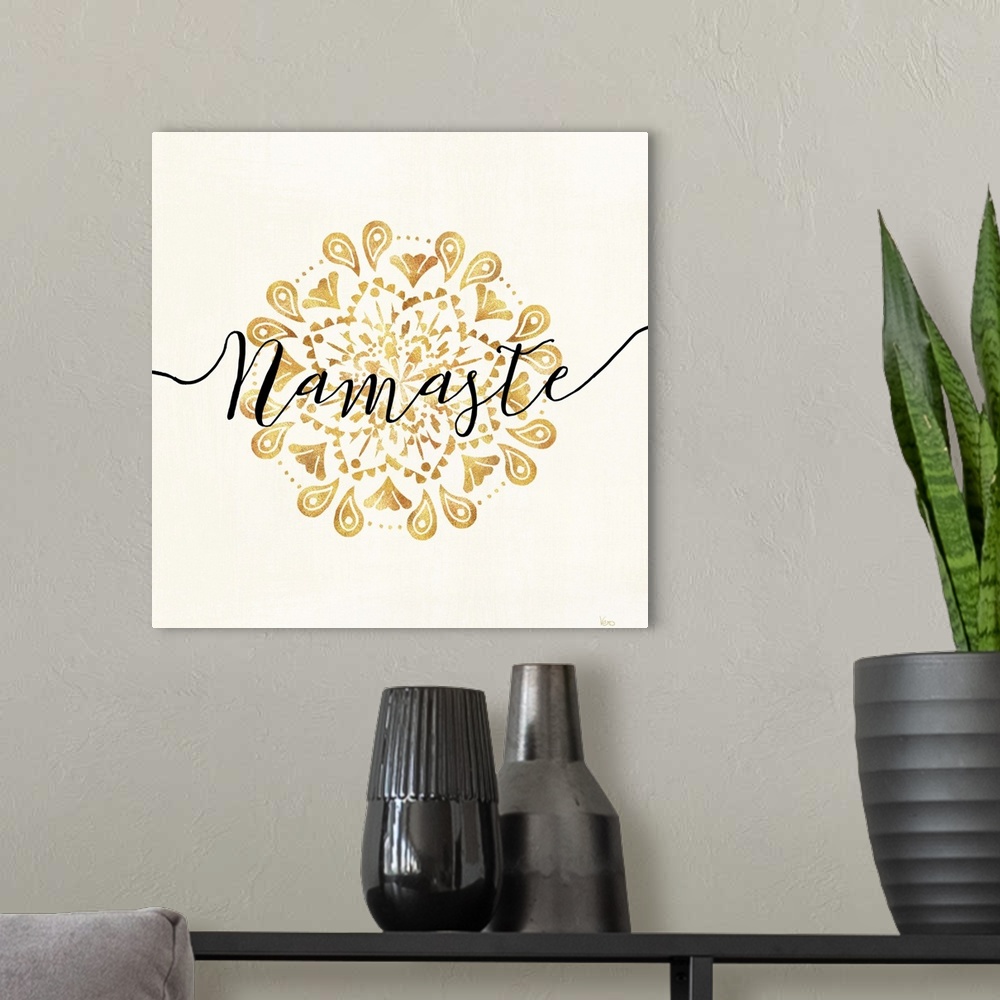 A modern room featuring Shiny gold mandala on a neutral background with the word "Namaste" written through the center.