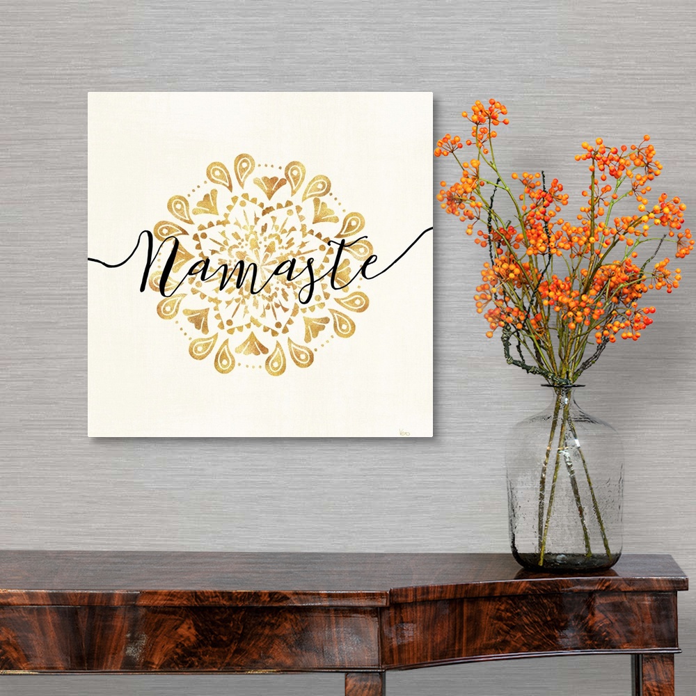 A traditional room featuring Shiny gold mandala on a neutral background with the word "Namaste" written through the center.
