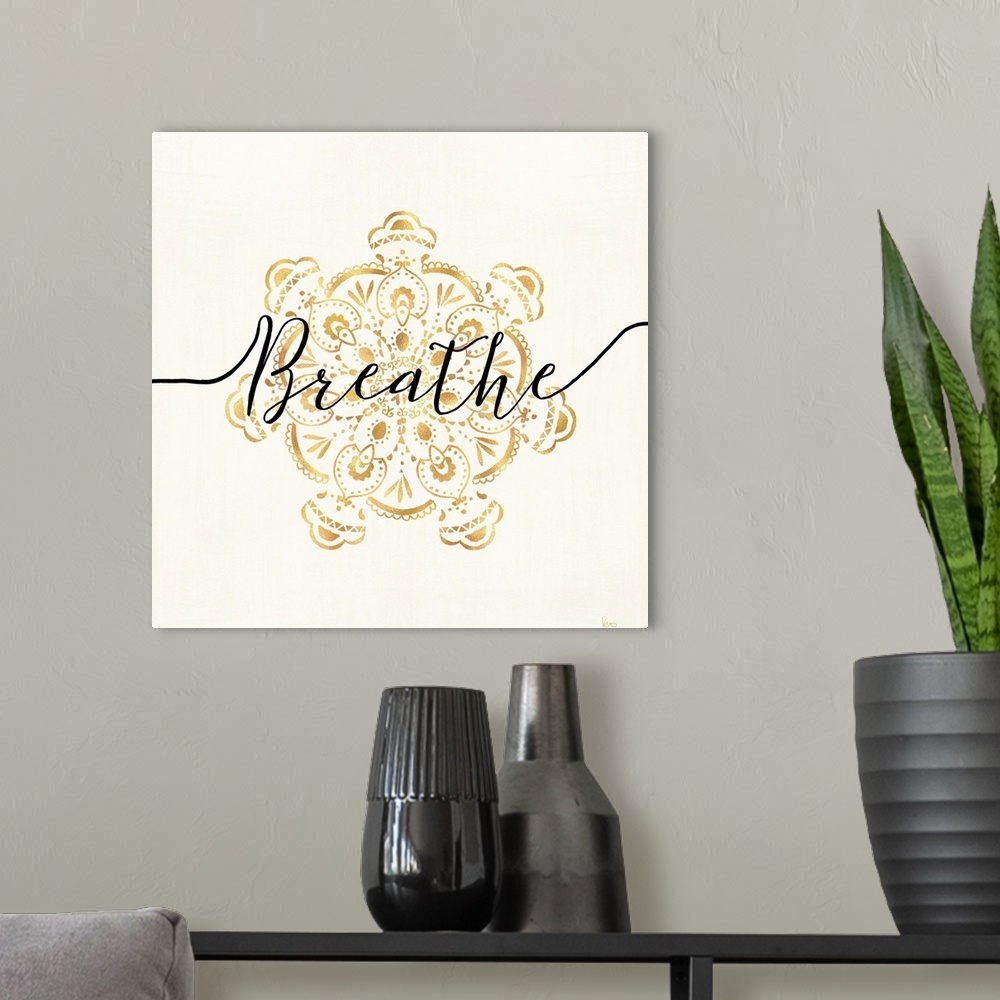 A modern room featuring Shiny gold mandala on a neutral background with the word "Breathe" written through the center.