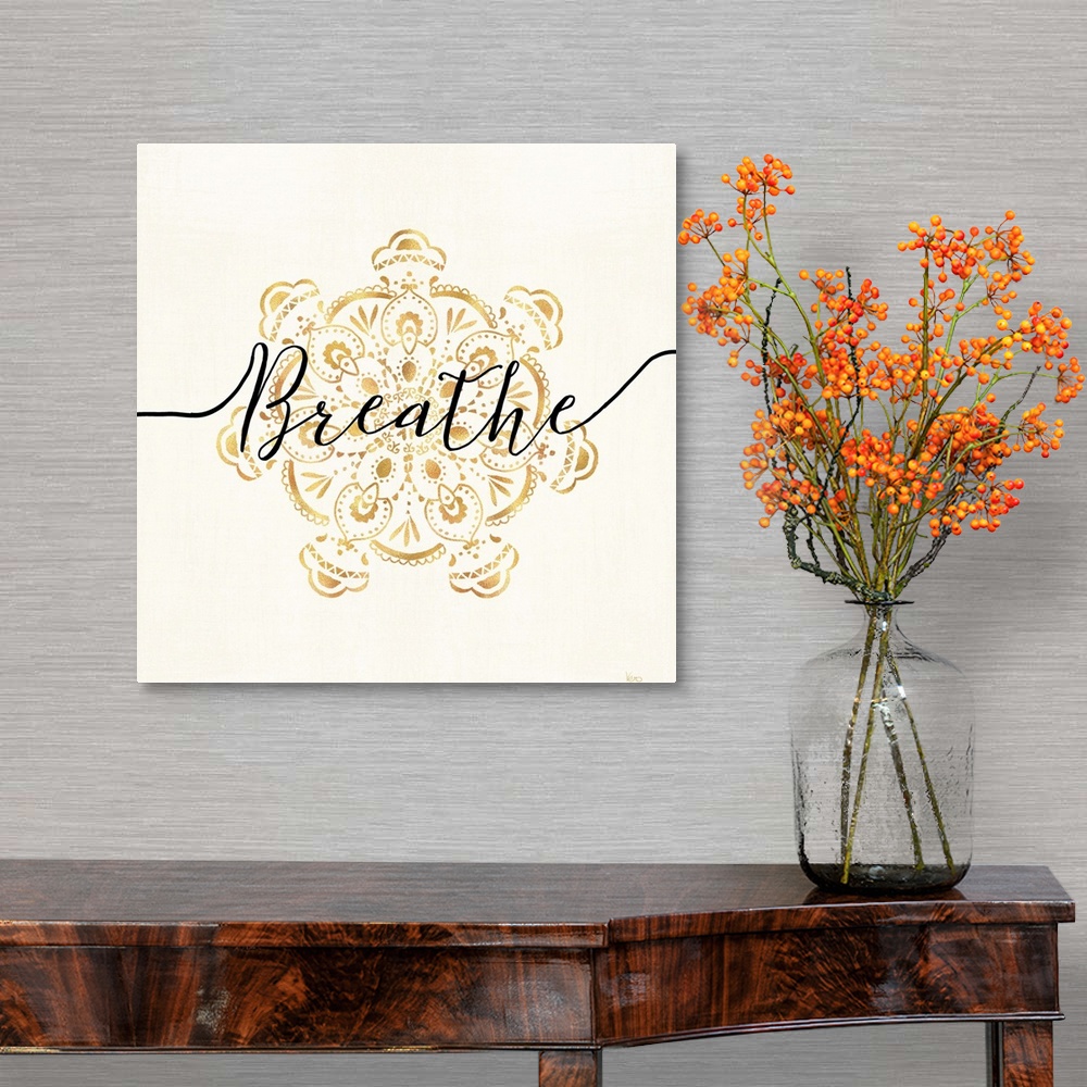 A traditional room featuring Shiny gold mandala on a neutral background with the word "Breathe" written through the center.