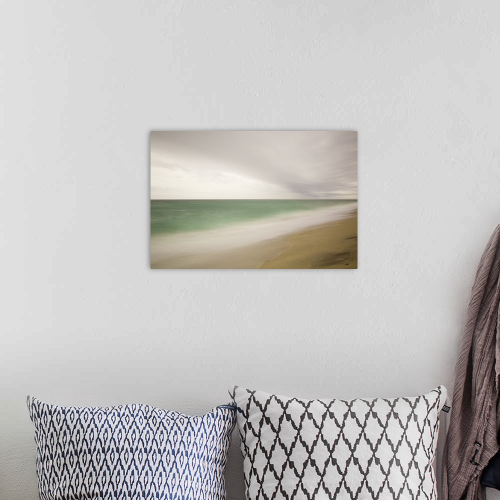 A bohemian room featuring Photograph of a beach with smoothed waves and clouds.
