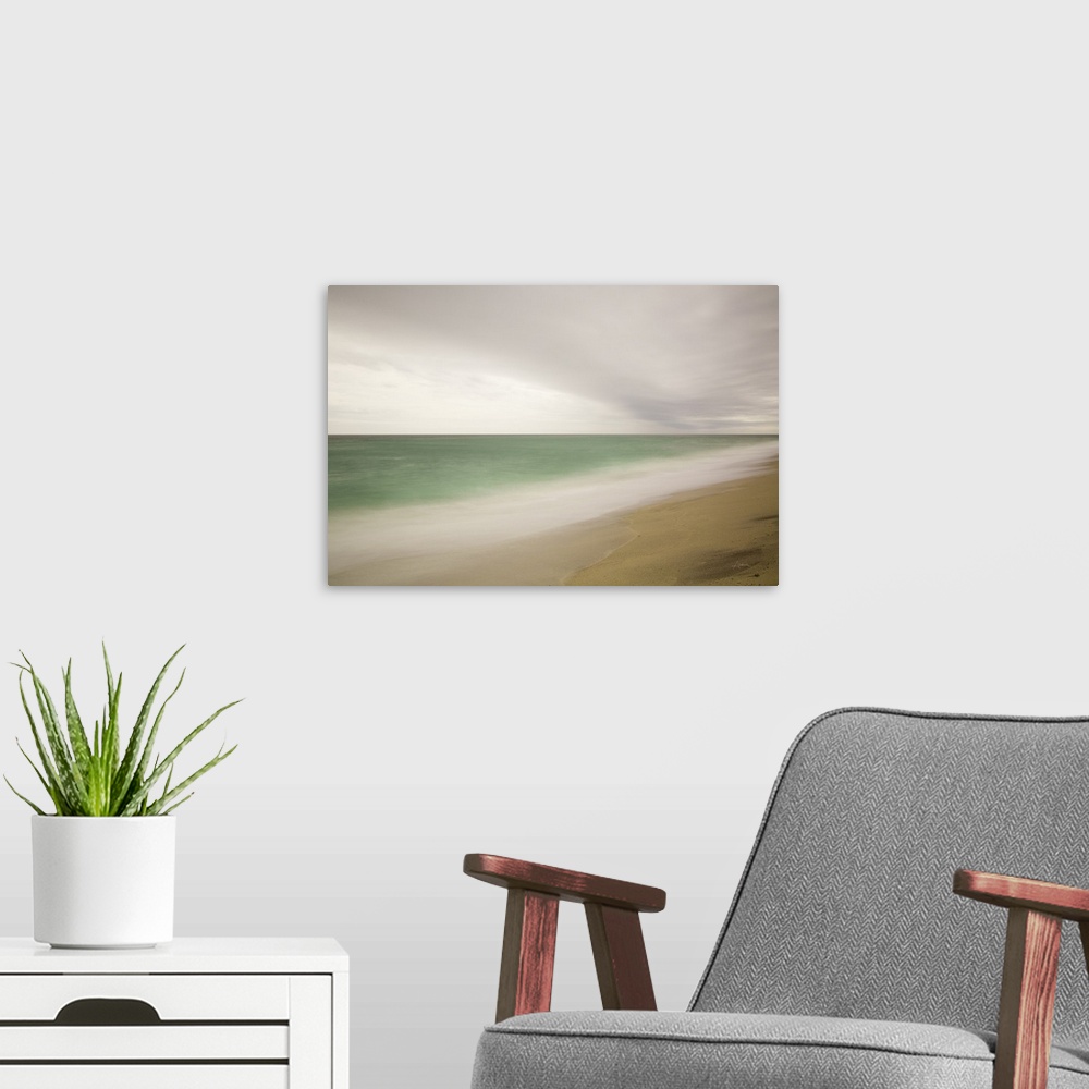 A modern room featuring Photograph of a beach with smoothed waves and clouds.