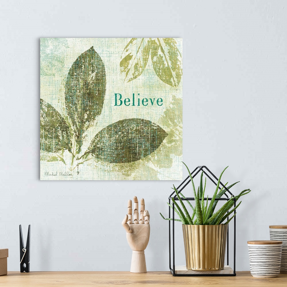 A bohemian room featuring Contemporary artwork of different types of leaves with the word "Believe" to the right of the image.
