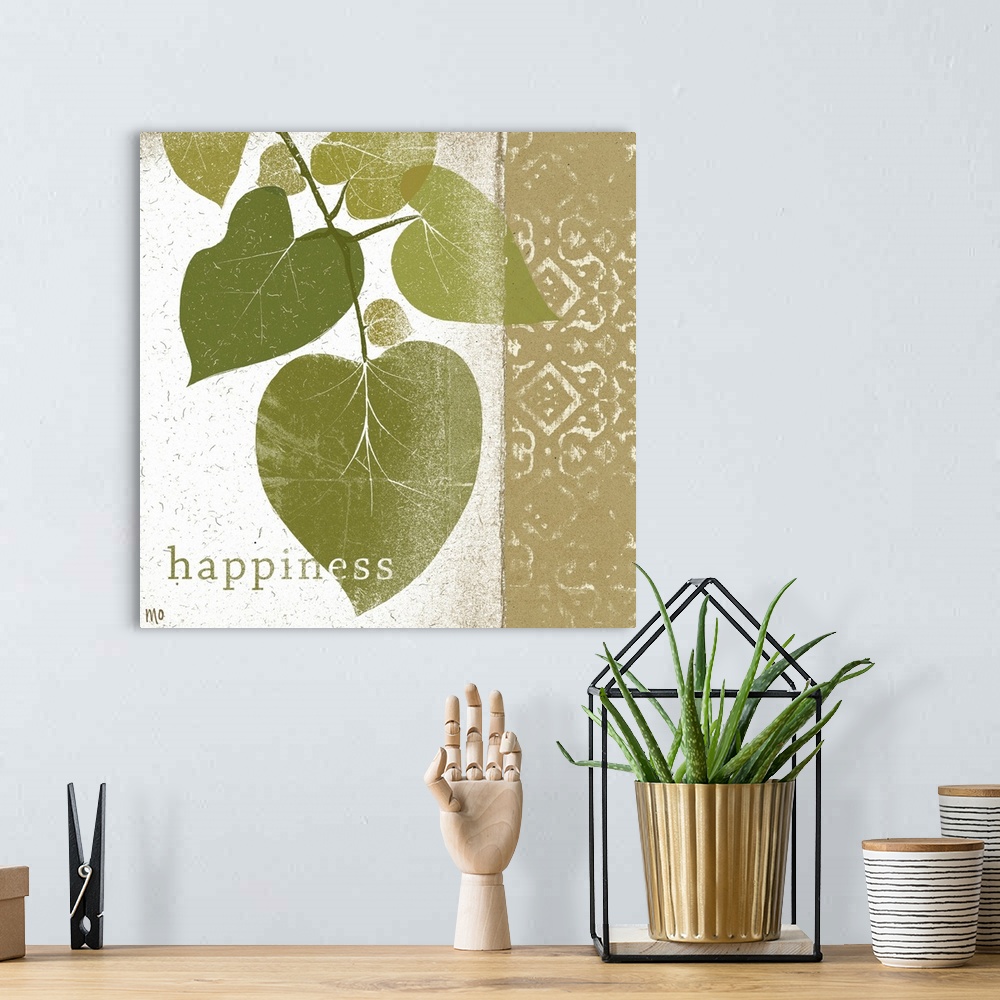 A bohemian room featuring Photo of a branch of leaves and a design with the word happiness at the bottom.