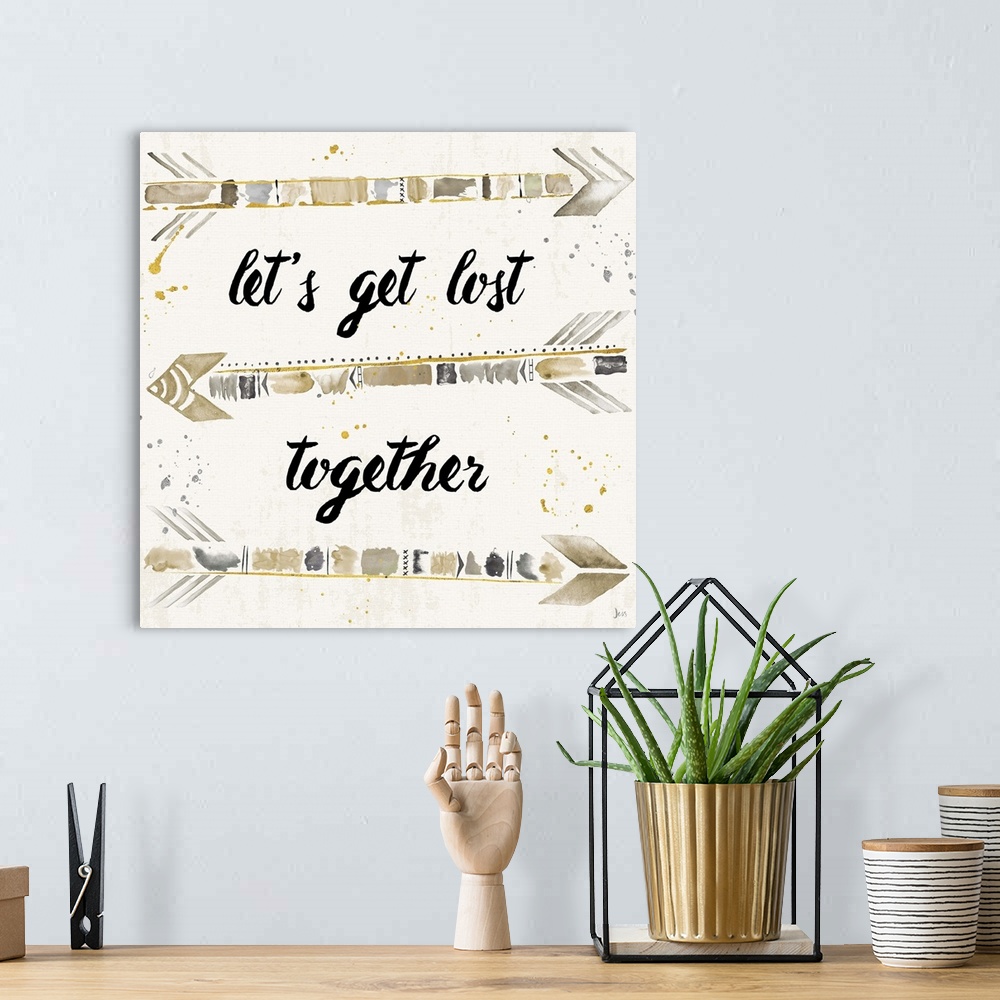 A bohemian room featuring "Let's Get Lost Together" with silver, gold, and beige arrows.