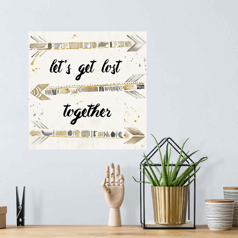 A bohemian room featuring "Let's Get Lost Together" with silver, gold, and beige arrows.