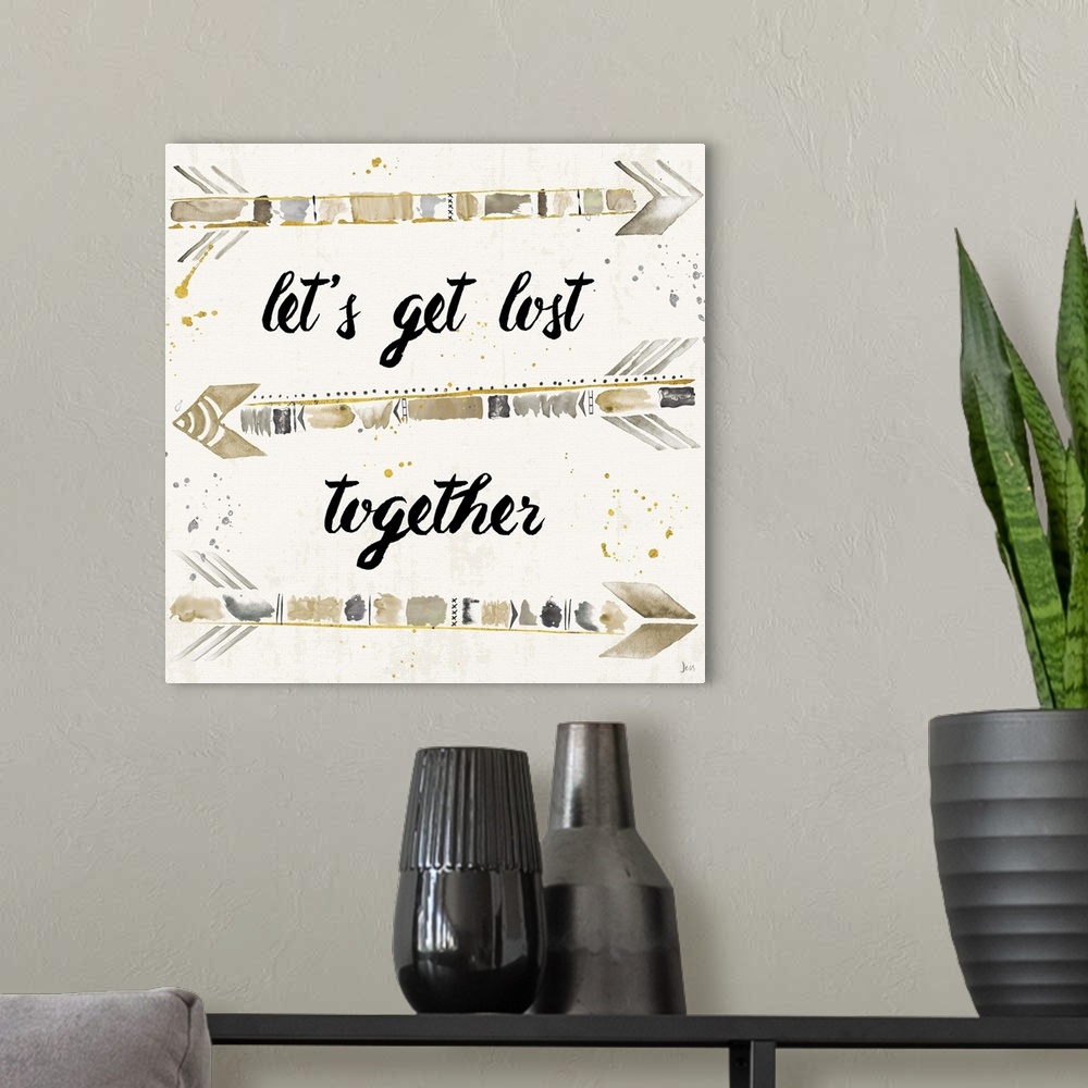 A modern room featuring "Let's Get Lost Together" with silver, gold, and beige arrows.