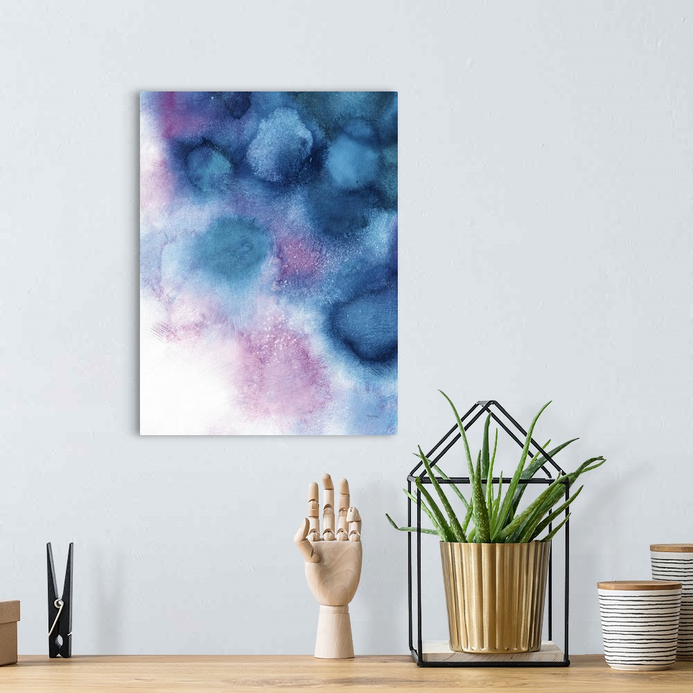 A bohemian room featuring Large abstract painting in blue and purple tones representing space nebula on a white background.