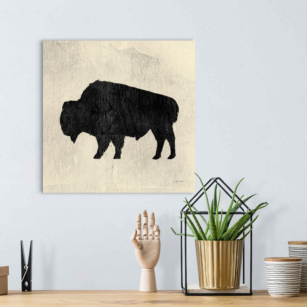 A bohemian room featuring Decorative artwork of a bison silhouette over cream colored background with paint brush textures ...