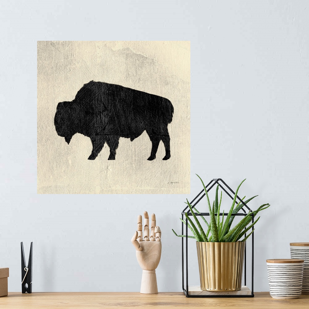 A bohemian room featuring Decorative artwork of a bison silhouette over cream colored background with paint brush textures ...