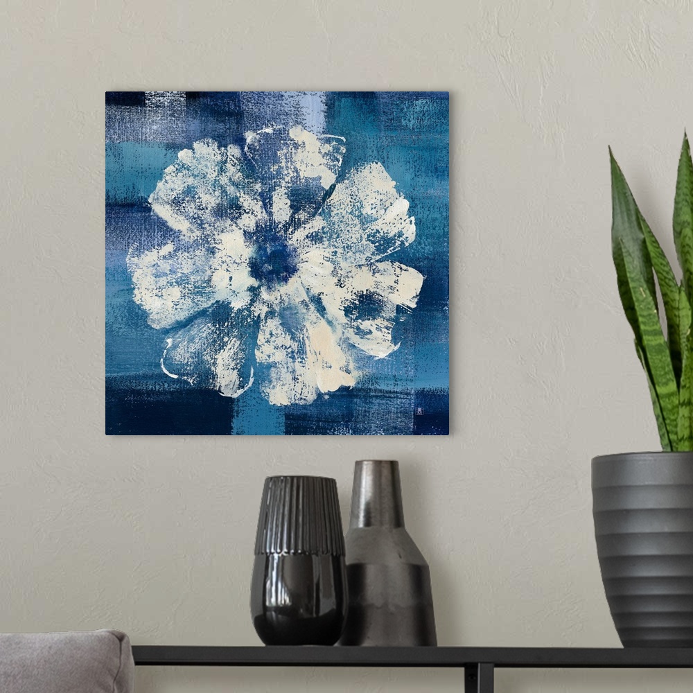A modern room featuring Square decor with a painting of a single white flower on a background made with shades of blue.
