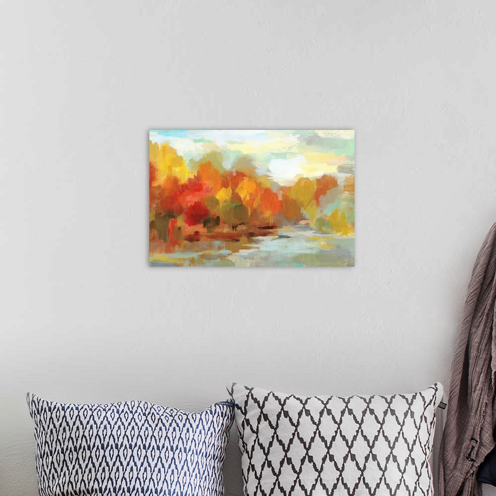 A bohemian room featuring Abstract painting of Fall trees and a blue sky made with short brushstrokes and many shades of co...
