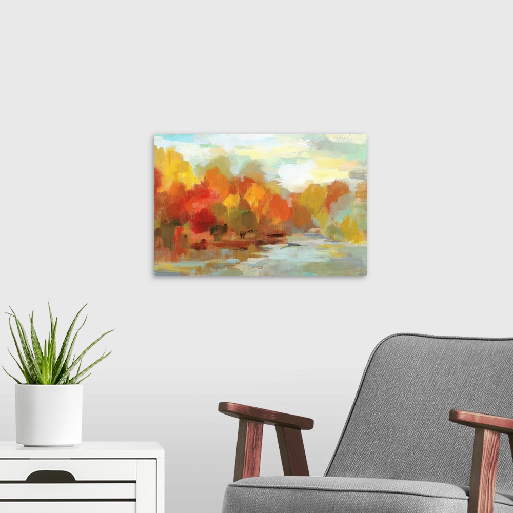 A modern room featuring Abstract painting of Fall trees and a blue sky made with short brushstrokes and many shades of co...