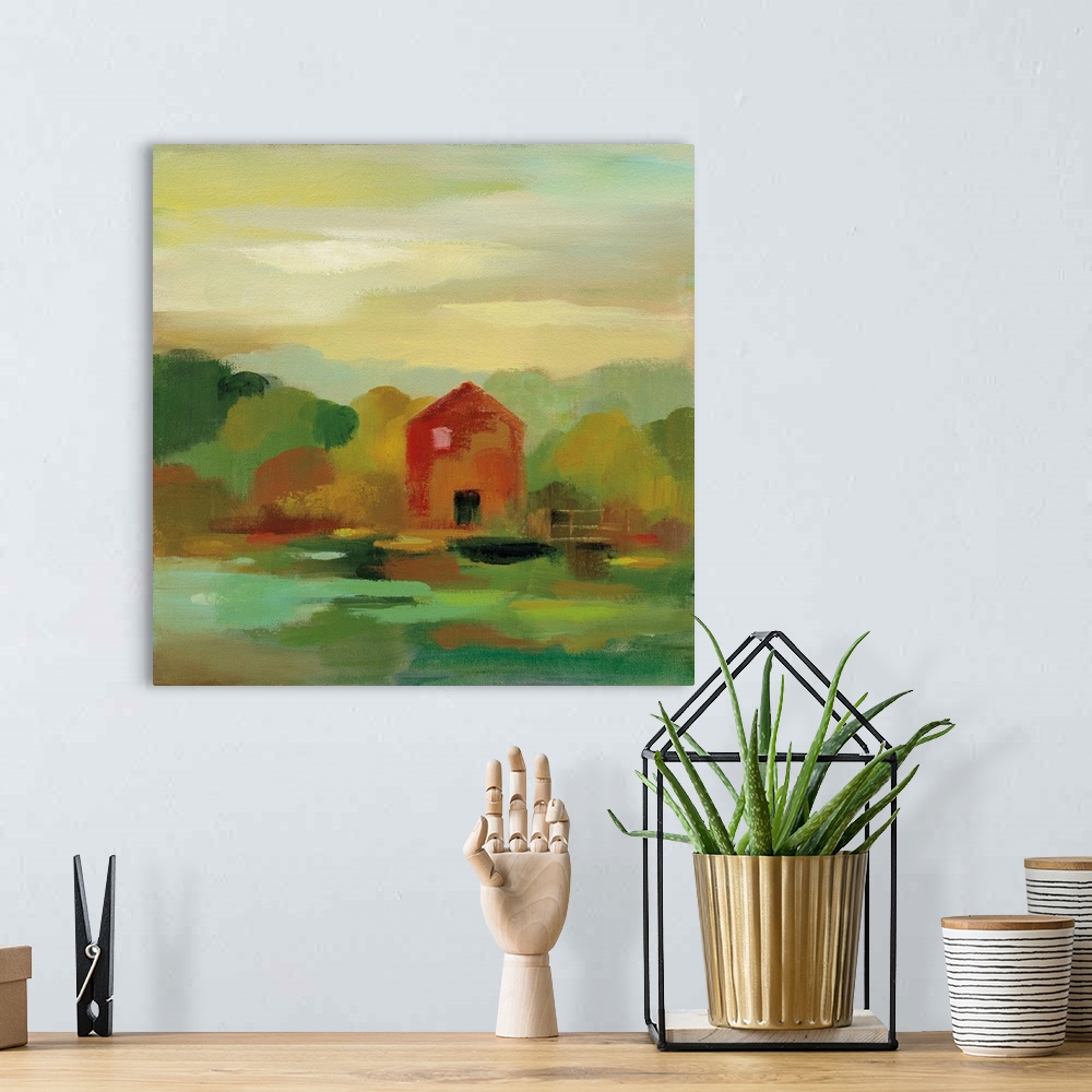A bohemian room featuring A contemporary painting of a red barn and fence framed by fall trees.