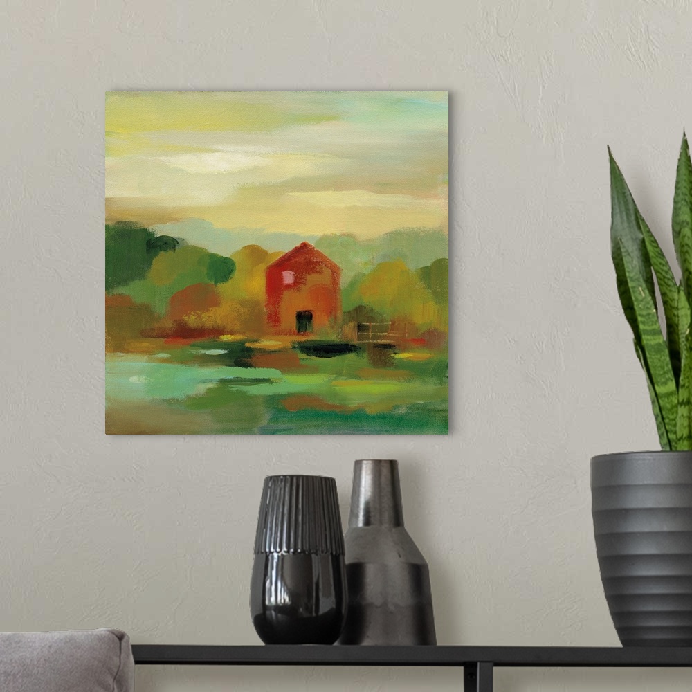 A modern room featuring A contemporary painting of a red barn and fence framed by fall trees.