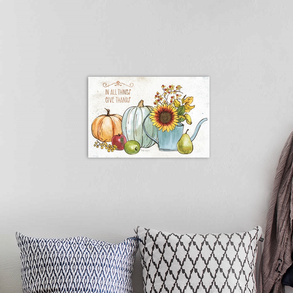 A bohemian room featuring Decorative artwork of autumn themed items with the words, 'In all things, give thanks'.