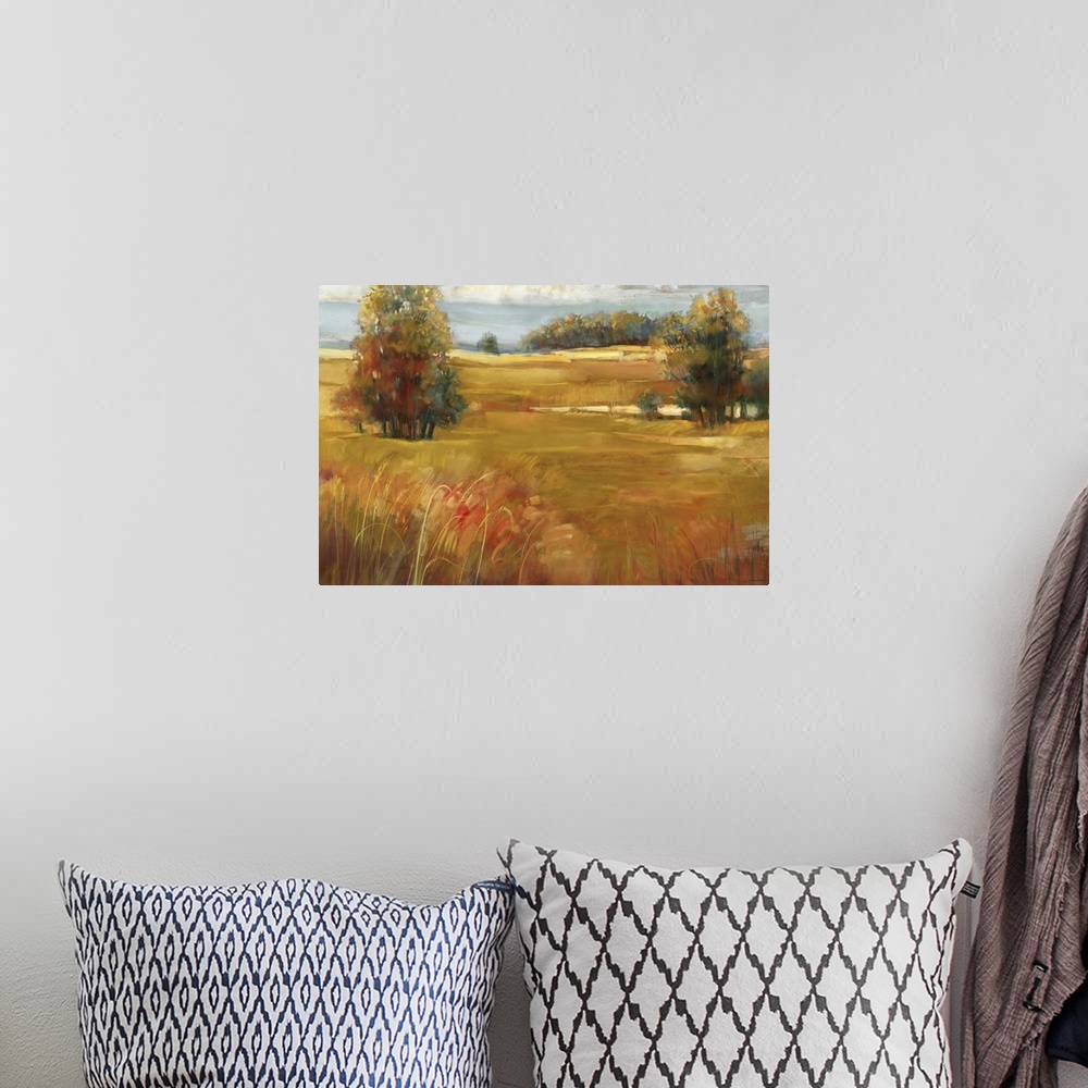 A bohemian room featuring Contemporary landscape painting of a grassy meadow dotted with trees in the late afternoon in the...