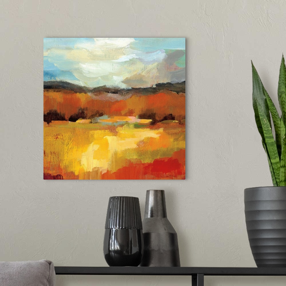 A modern room featuring Square abstract painting of an Autumn tree scene with a blue sky.