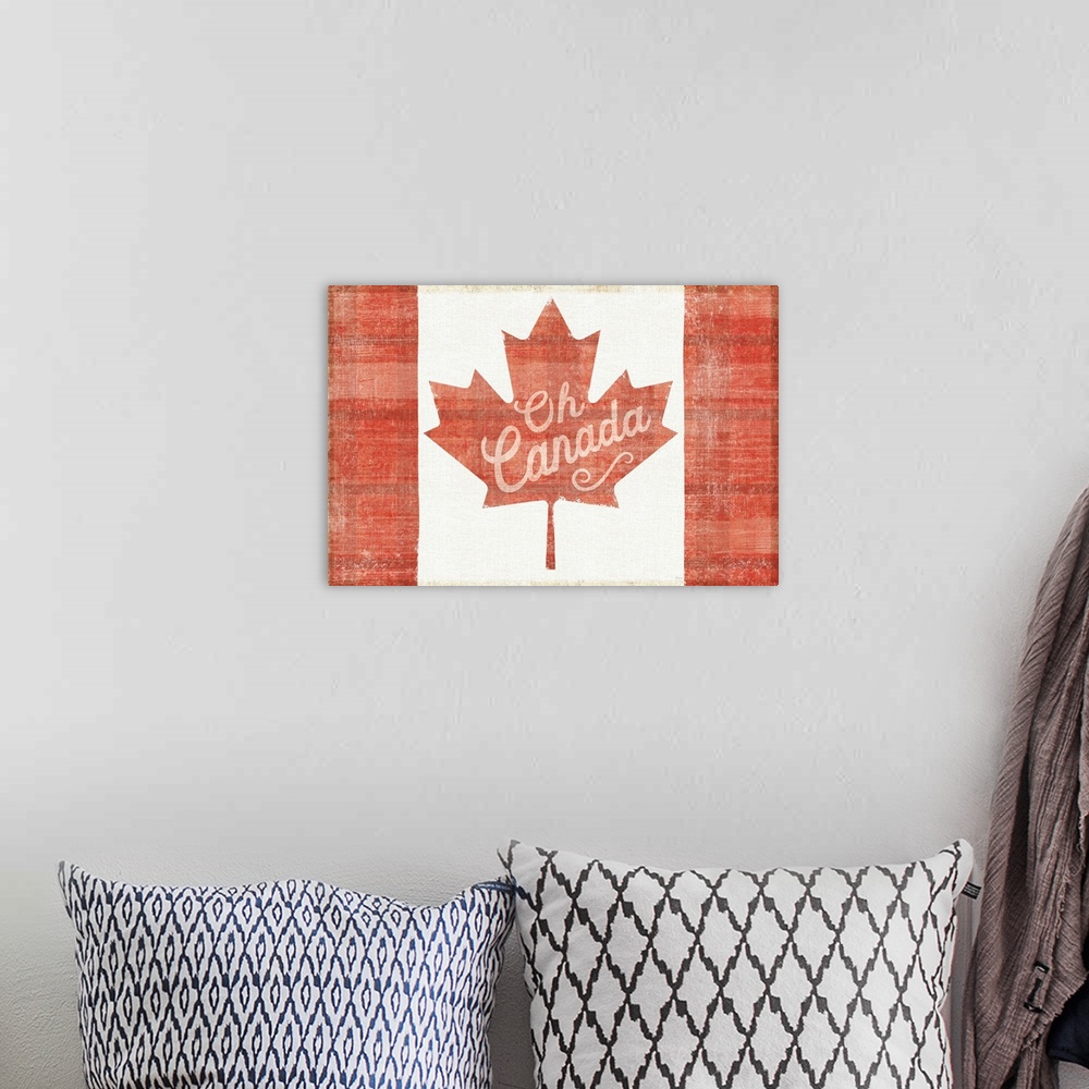 A bohemian room featuring Red and white plaid patterned Canadian flag with the phrase "Oh Canada" written on the red maple ...