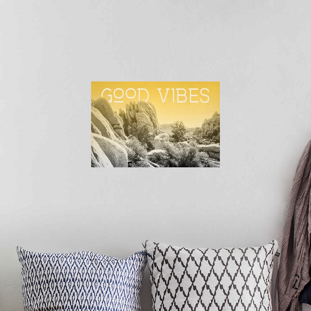 A bohemian room featuring "Good Vibes" on a horizontal rocky landscape image with a yellow overlay.