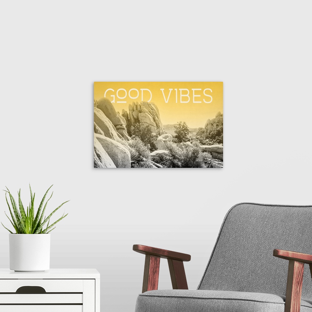 A modern room featuring "Good Vibes" on a horizontal rocky landscape image with a yellow overlay.