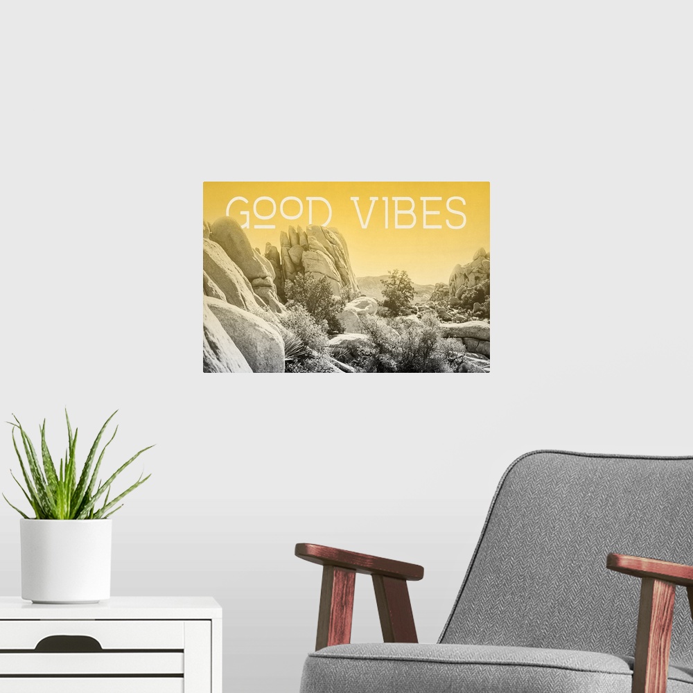 A modern room featuring "Good Vibes" on a horizontal rocky landscape image with a yellow overlay.