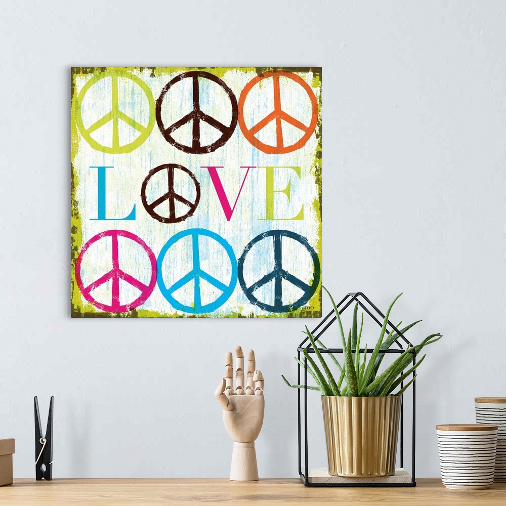 A bohemian room featuring Retro artwork of the word "LOVE" surrounded by colorful peace sign symbols.