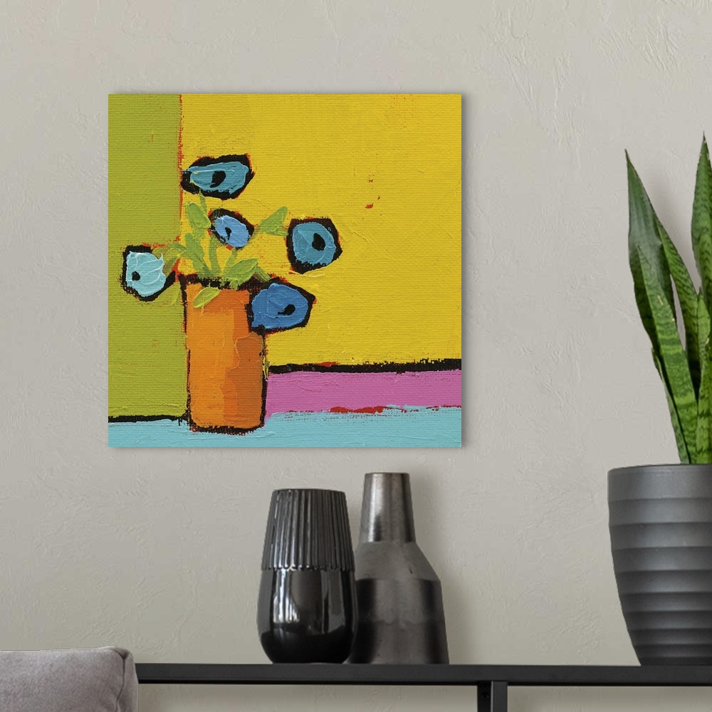 A modern room featuring Bright square abstract painting of an orange vase with bright blue flowers on a multicolored back...