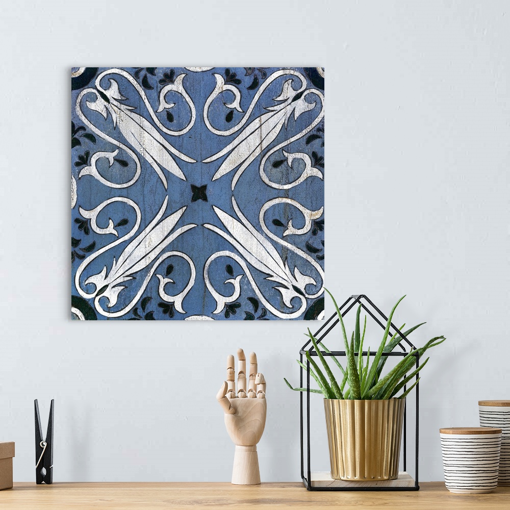 A bohemian room featuring Square abstract painting of a symmetric indigo and white tile-like design.