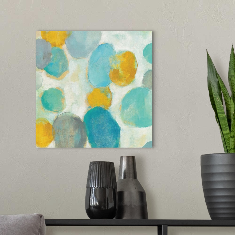 A modern room featuring Abstract artwork of bright circle shapes in yellow and teal.