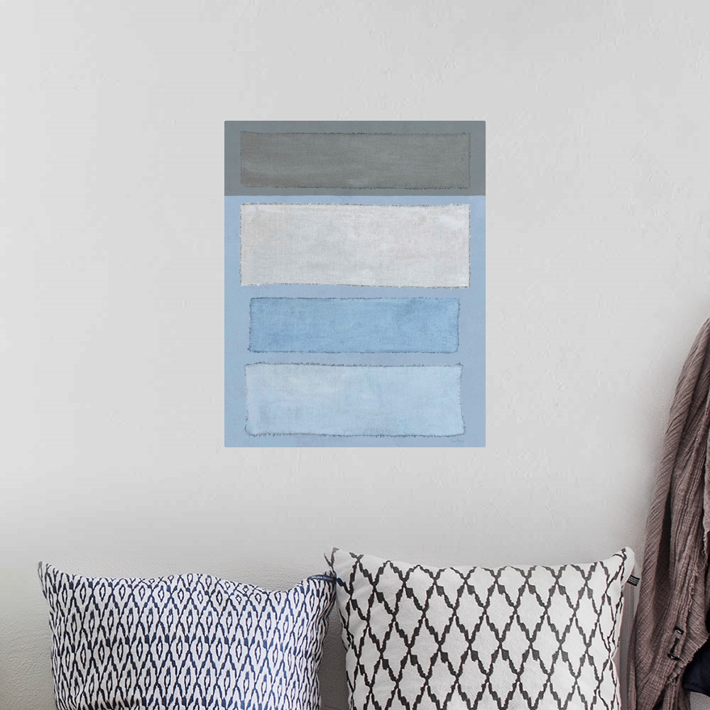 A bohemian room featuring Mixed media art with blue and gray linen rectangles placed horizontally on a vertical canvas with...